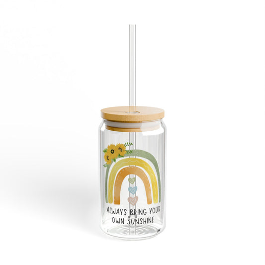 Clear tumbler with a rainbow design, sunflower, and text 'Always bring your own sunshine' on a white background.